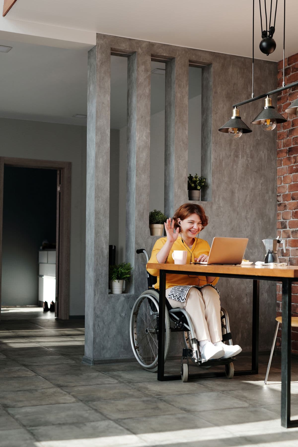 A man using a wheelchair preparing food in his accessible home kitchen